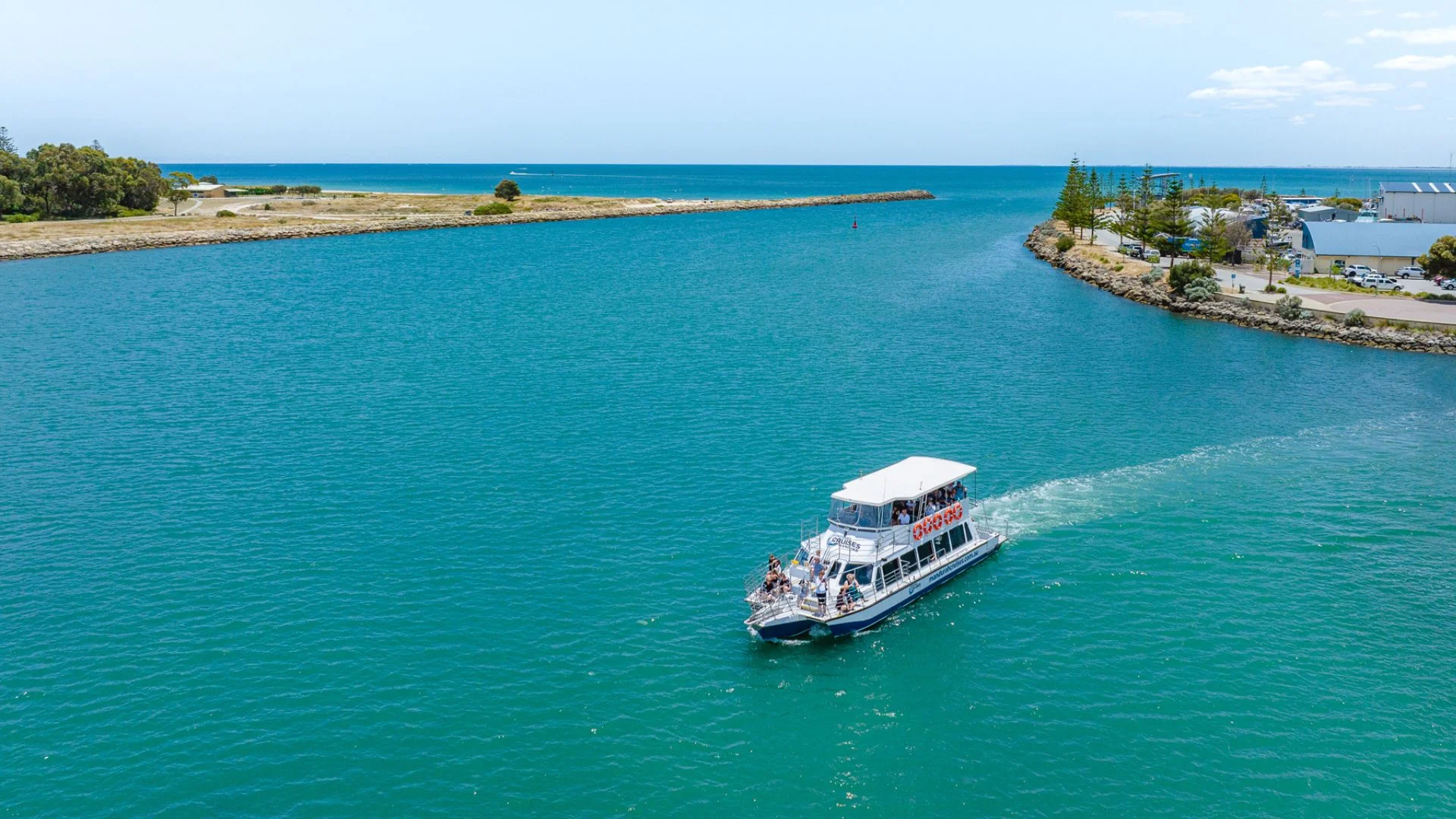 Aerial view of a tour boat cruising through the Mandurah Estuary.