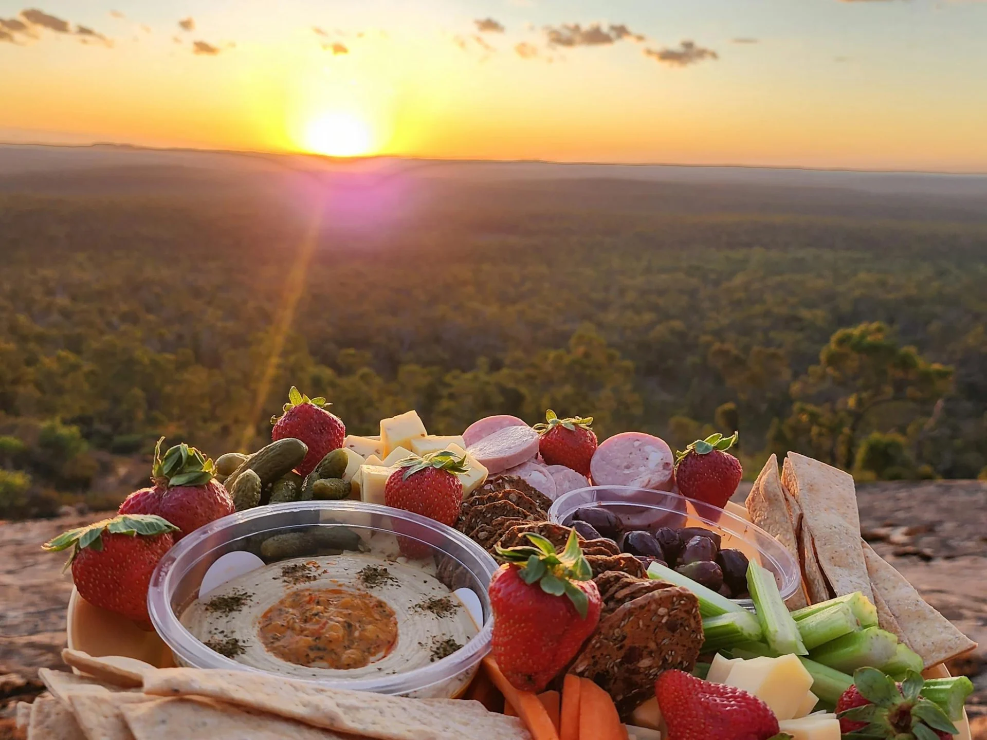 sunset gourmet grazing platter with sunset behind from atop Darling Range mountail