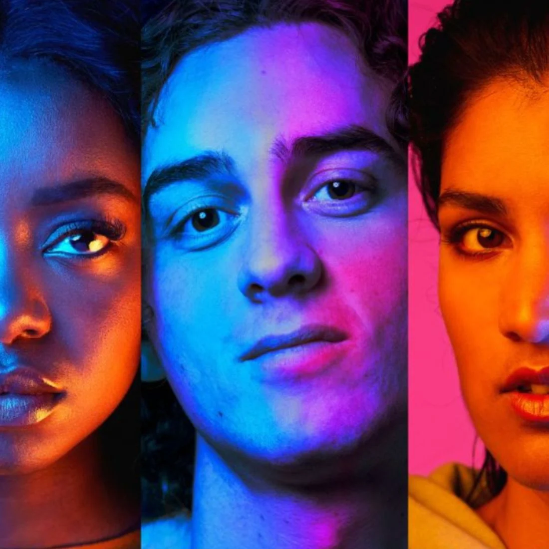 Three young people with serious expressions are lit by bold blue, pink, and orange lights.