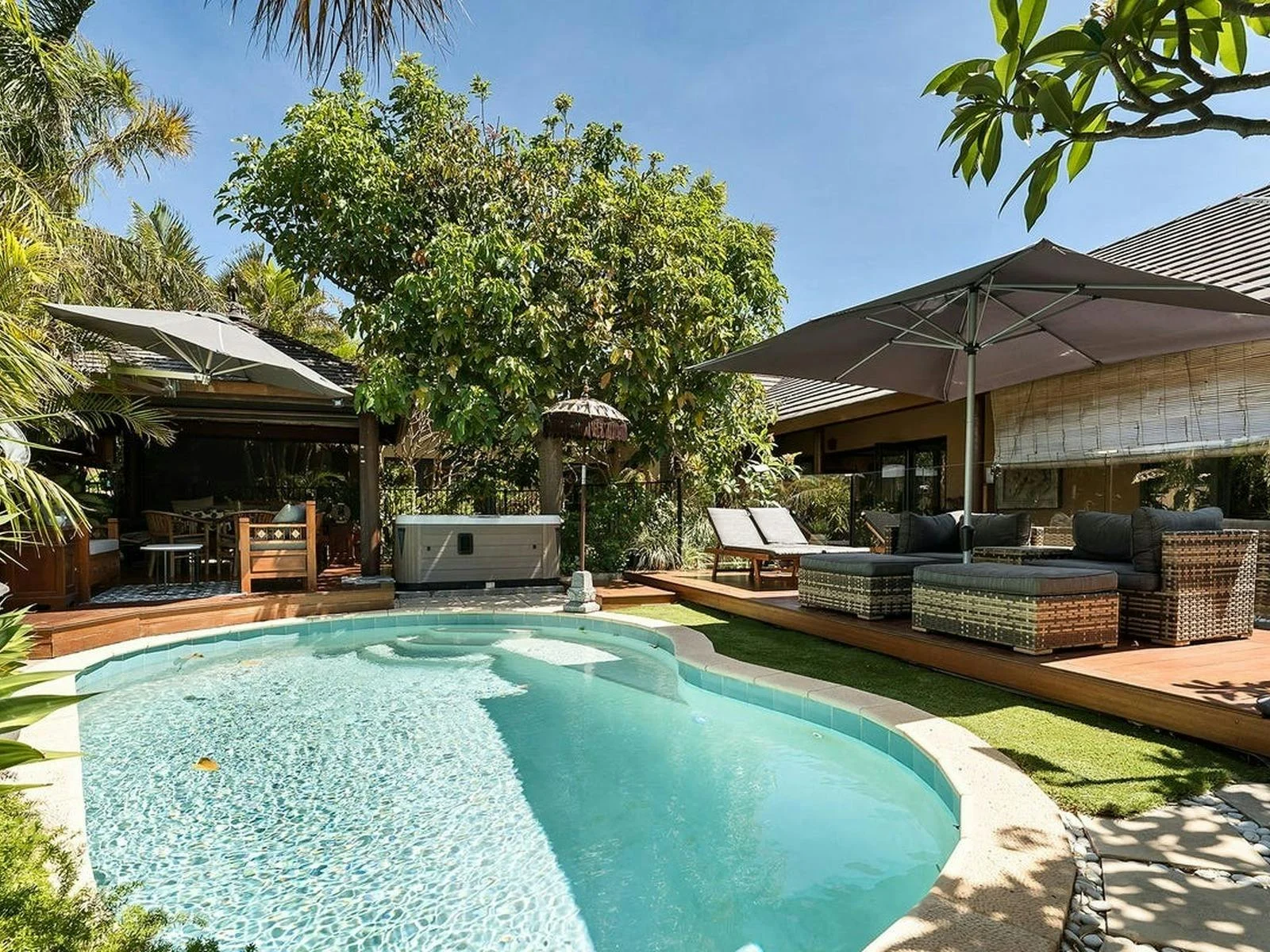 Pool and timber deck with tropical gardens and outdoor lounge at Bali at Avalon, Falcon WA