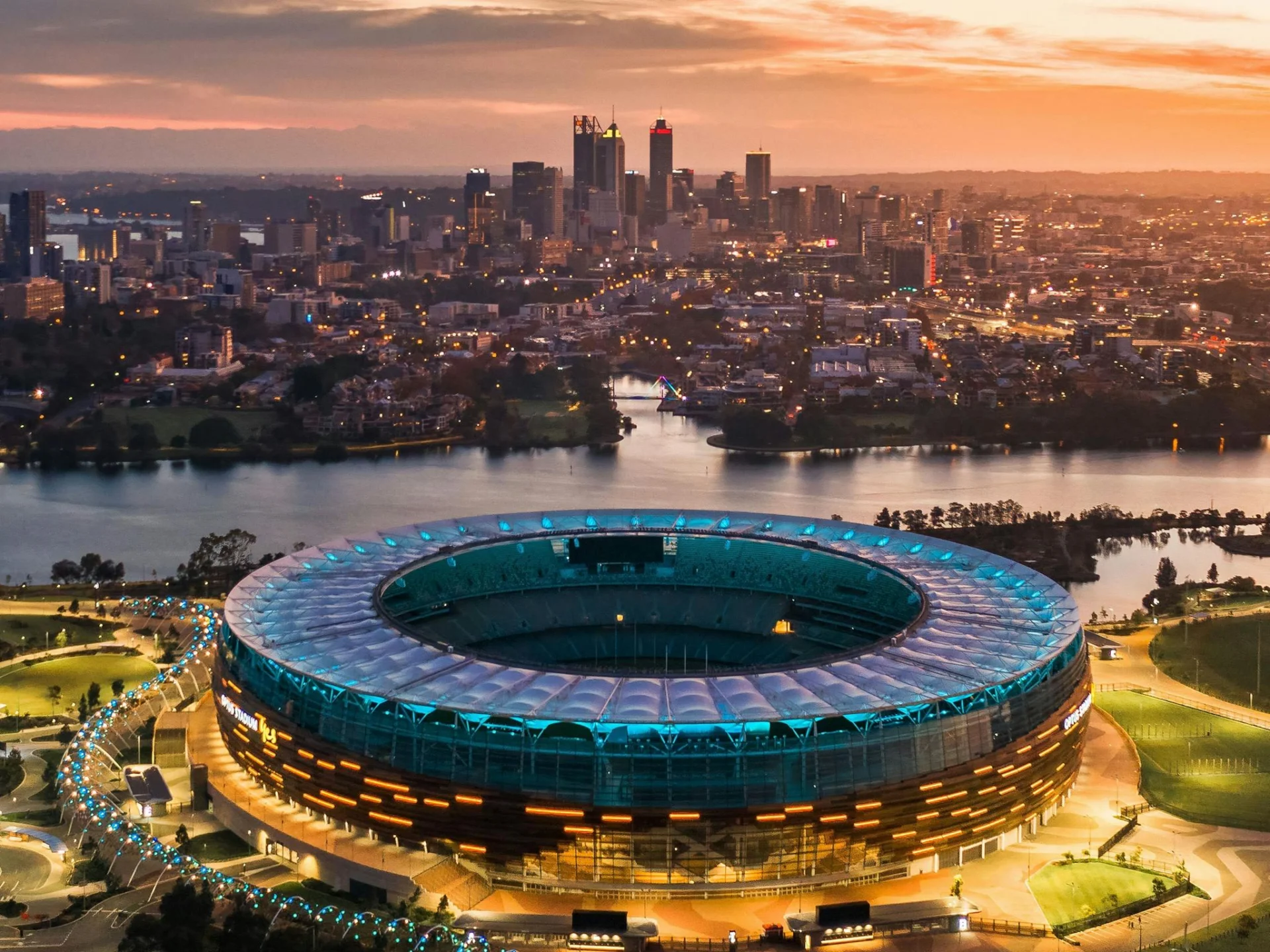 Aerial view of Optus Stadium and Perth skyline at sunset