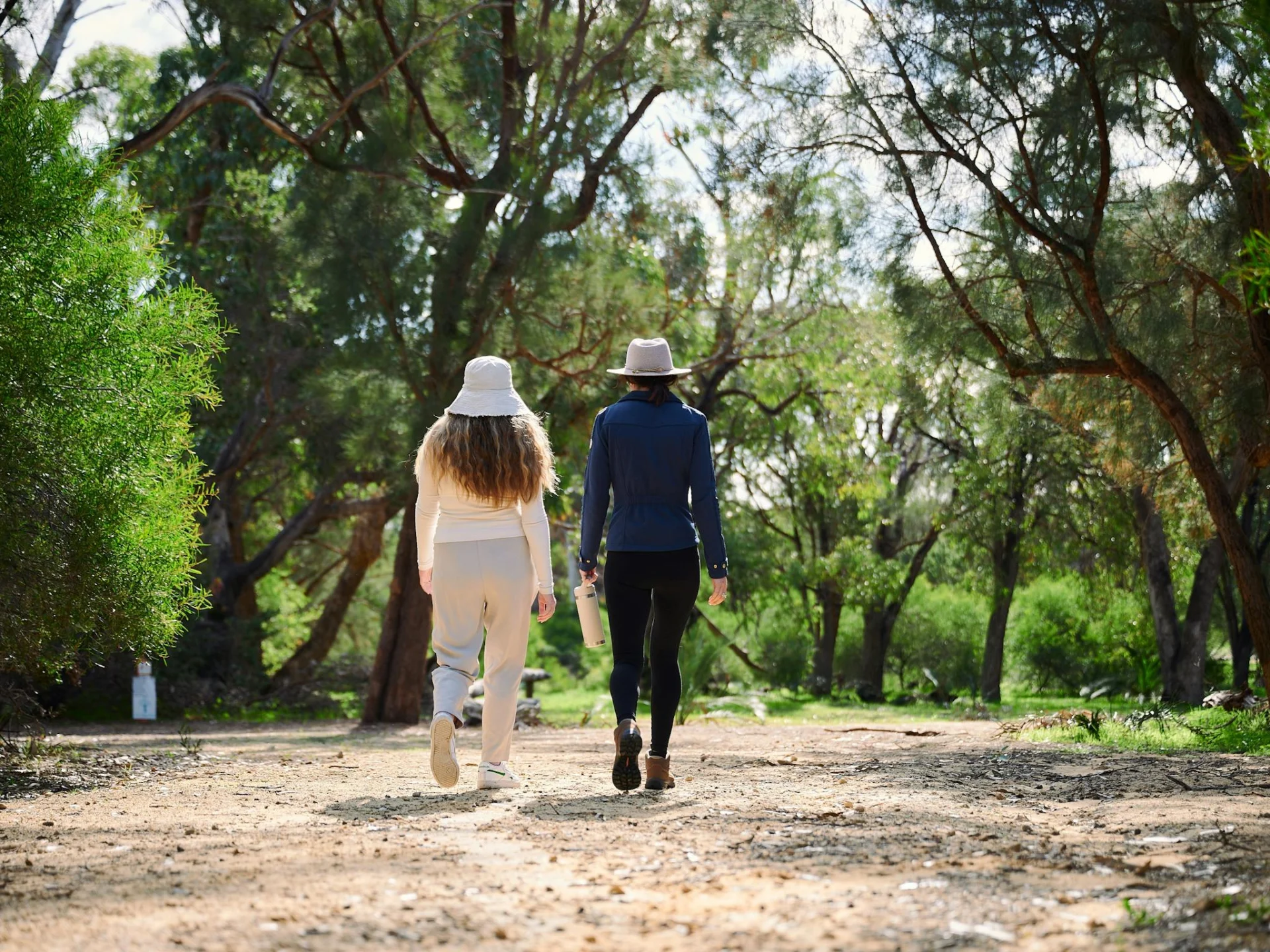 Two women walking down pathway