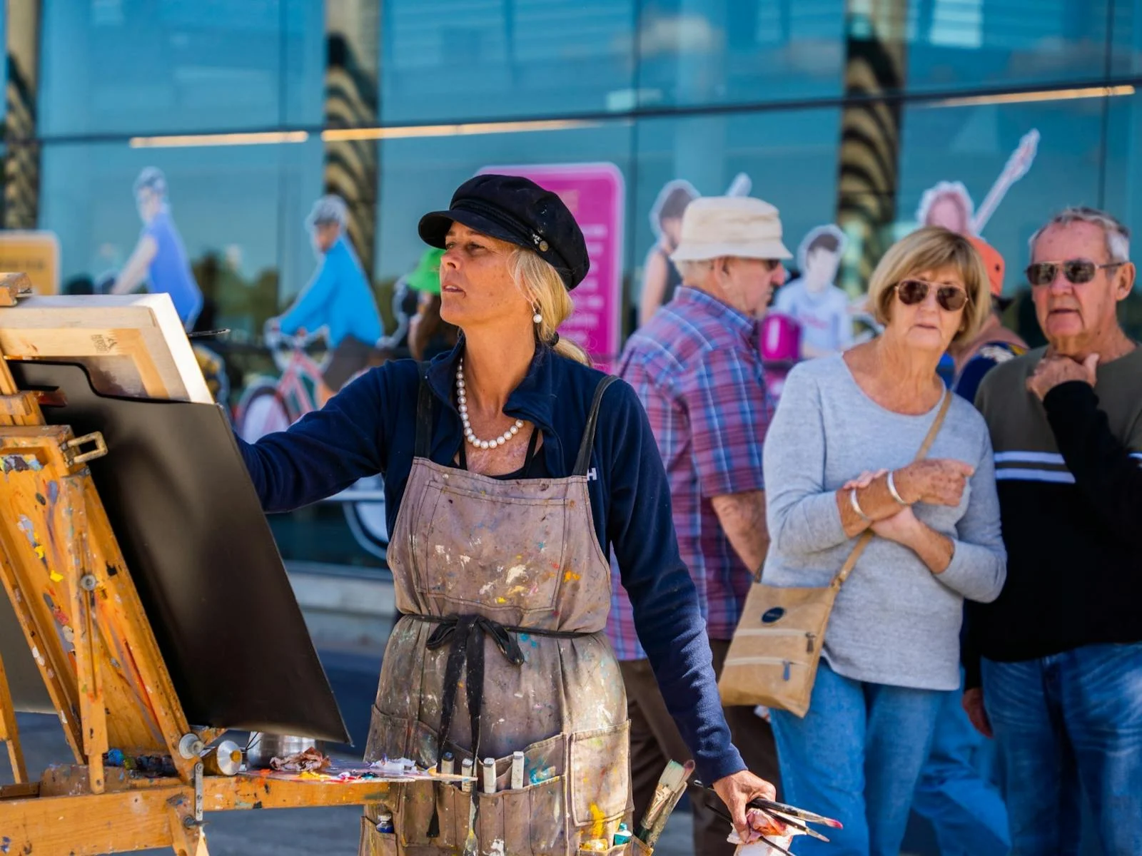 Artist Leanne Pearson painting outdoors with spectators watching at Plein Air Down Under