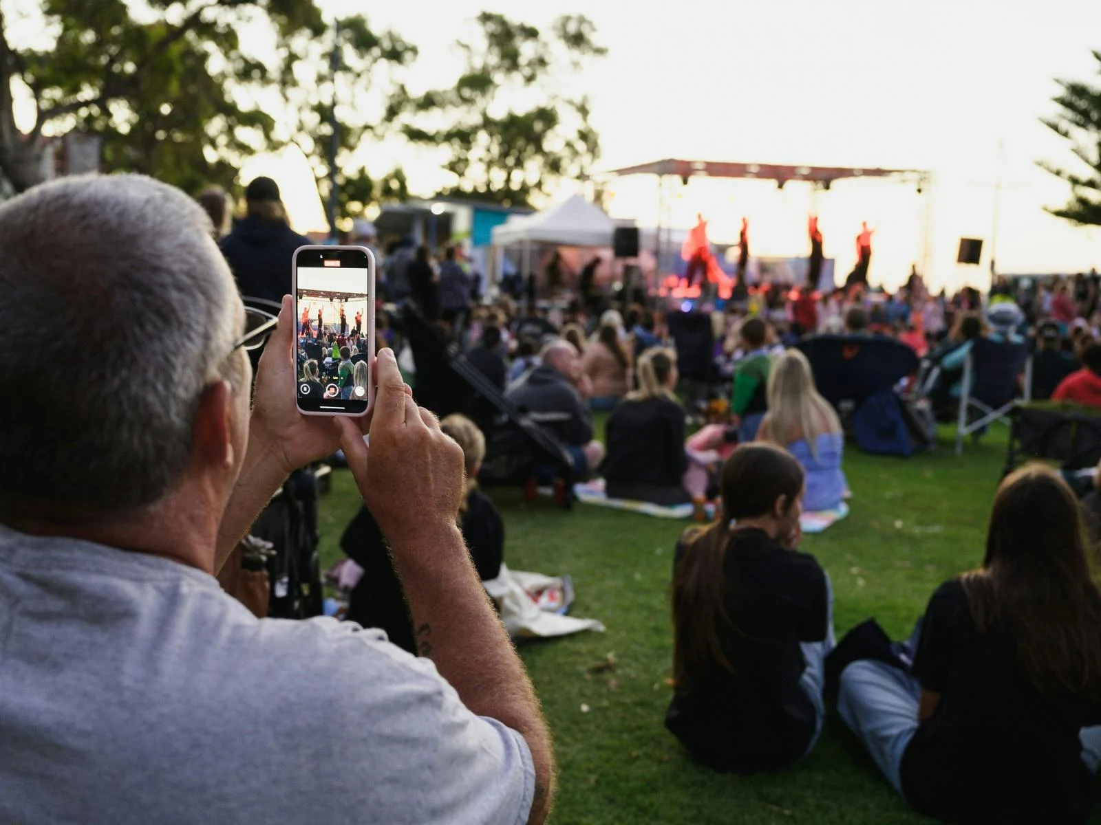 Man taking a photo of stage