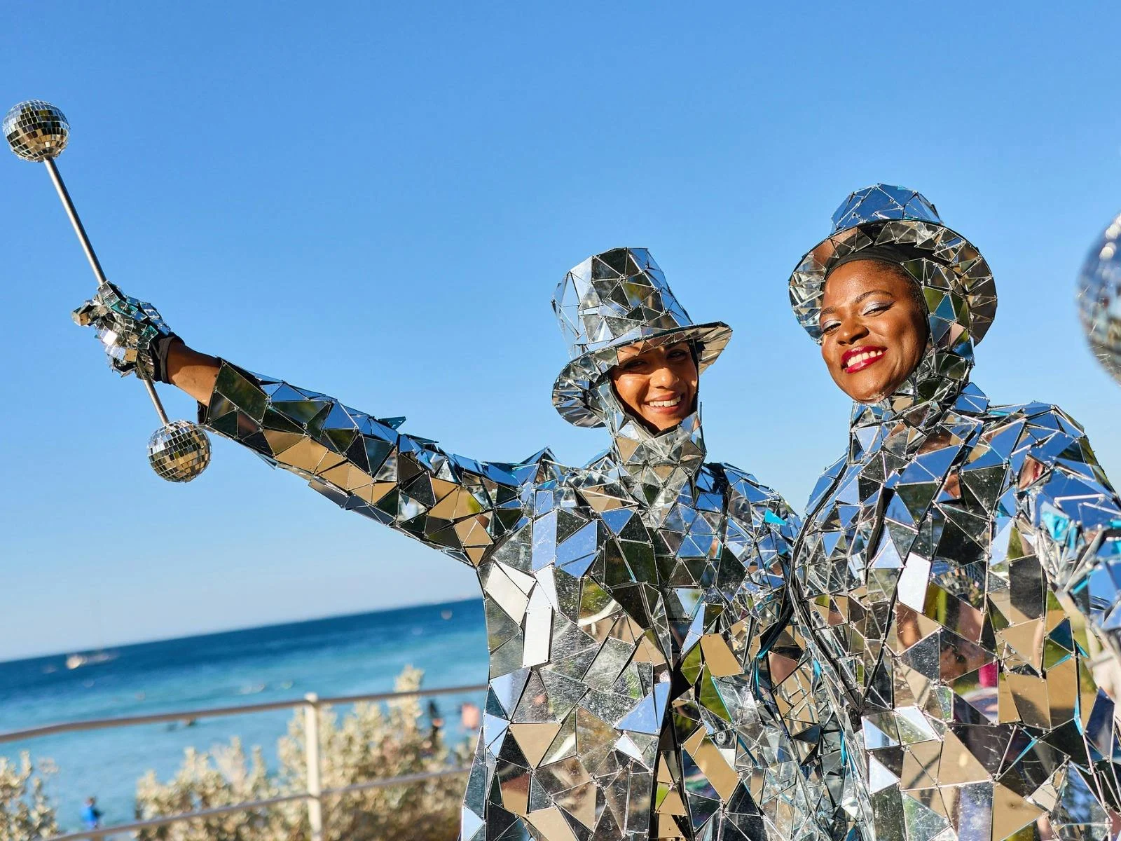 Two entertainers dressed in a fully mirrored suit